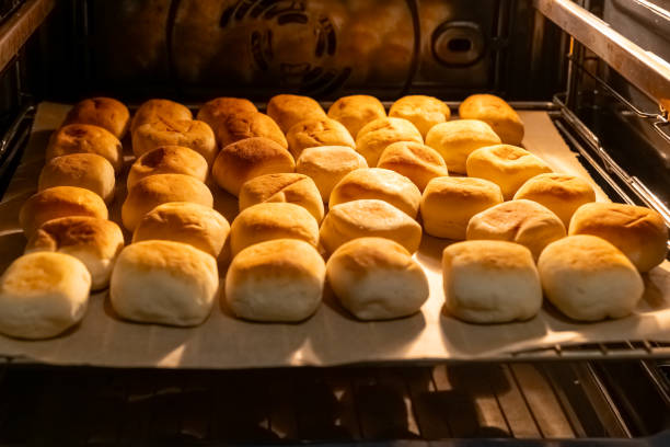 istock Freshly baked rolls cooling in an oven with golden brown crust 2200140788
