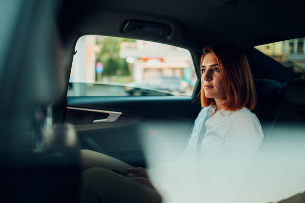 istock Businesswoman reflecting while traveling in a car 2200141571