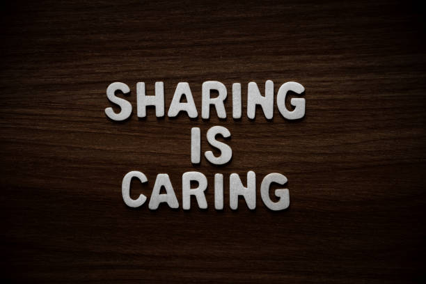istock Sharing is caring - Wooden letters on walnut background 2200141641