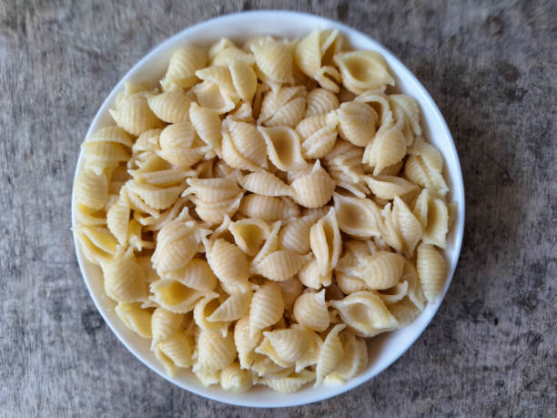 istock Tasty Shell Conchiglie Macaroni Pasta On A Plate. Food Menu. Top View. 2200142290