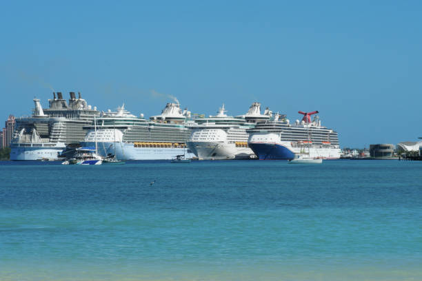 Nassau, Bahamas 12 03 2023: Four luxury cruise passenger ships observed from a cargo container terminal in Nassau harbour, Bahamas, one of the Caribbean islands during sunny winter day.