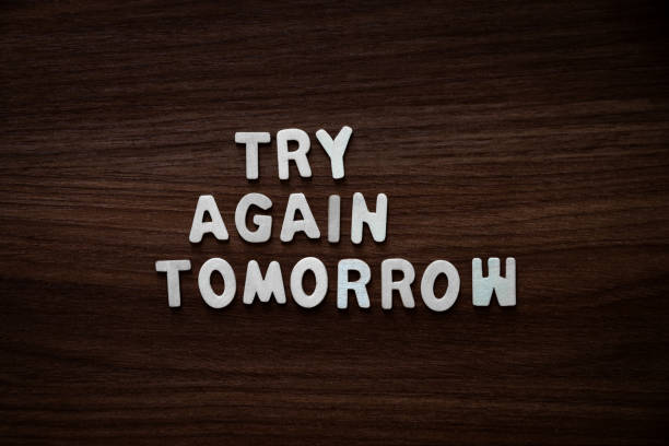 Try again tomorrow - Wooden letters on walnut background