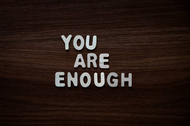 You are enough - Wooden letters on walnut background