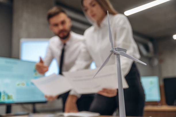 istock Having a conversation. Two employees are working in wind turbine company 2200146544