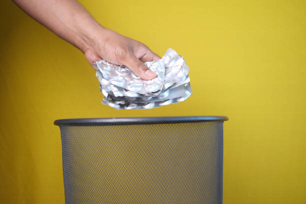istock A hand is throwing away expired medicine packet into a trash can. 2200147404
