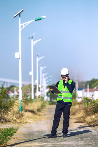 istock Male engineer writing on clipboard with countryside in the background 2200147790