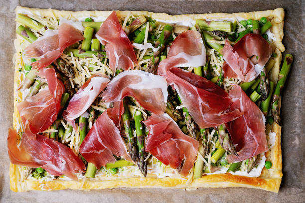 istock Puff pastry tart with asparagus, peas, goat cheese and prosciutto 2200147984