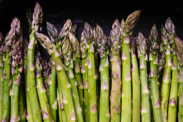 istock Fresh Green Asparagus on the ceramic form 2200148259