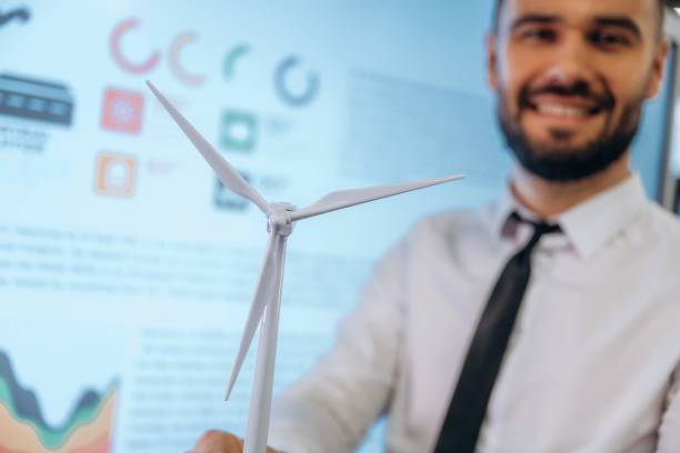 istock Ecology conception. Man is working in the wind turbine company 2200148791