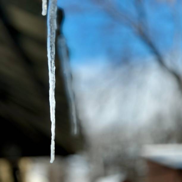 istock Icicle Hanging from Roof in Winter 2200148804
