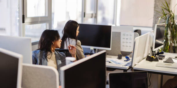 istock Businesswomen working on computers in modern office 2200151464