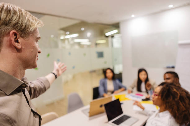 istock Businessman leading meeting with diverse team in modern office 2200151627