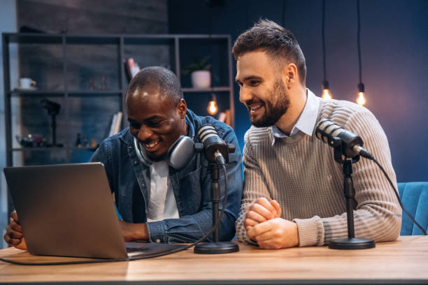 istock Modern technology, with laptop. Two radio presenters recording an audio broadcast in a studio 2200155920