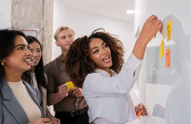 istock Marketing team brainstorming and planning using sticky notes on whiteboard 2200157577