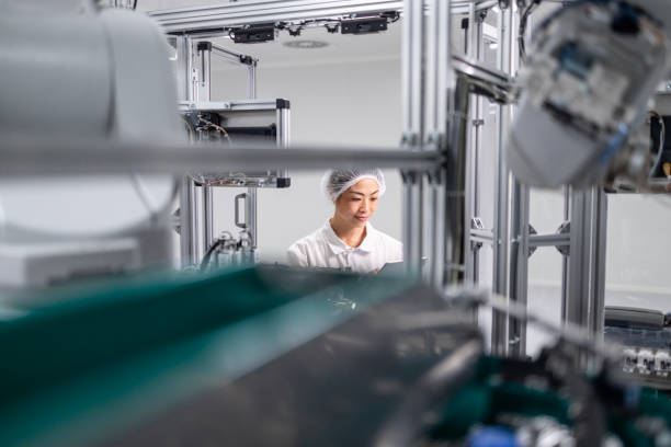 istock East Asian engineer working in advanced technology factory. Robotic machines in background. 2200158914