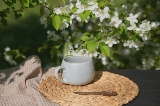 Relaxing tea time in a garden surrounded by blooming flowers