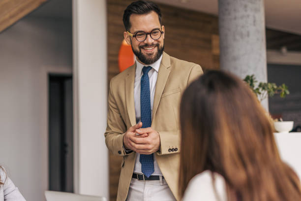 istock Smiling businessman engaging in office discussion 2200162165