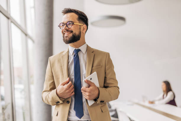 istock Confident businessman holding tablet in office 2200162567