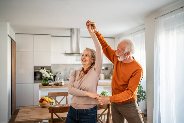 istock Happy senior couple dancing together in their modern kitchen 2200162787