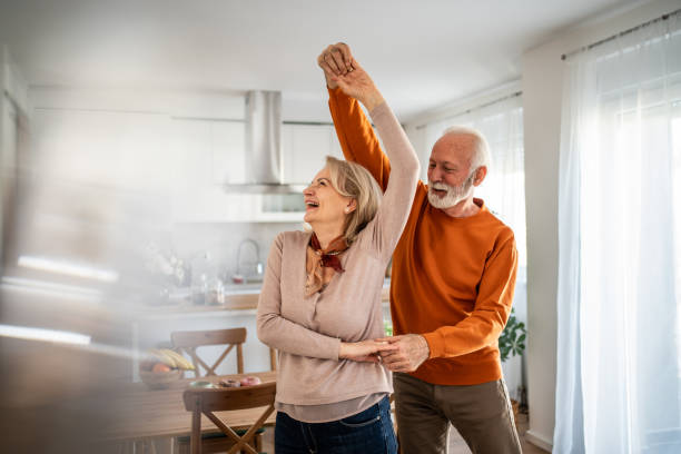 istock Happy senior couple dancing together in their modern kitchen 2200162831