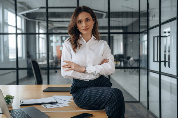 istock On the table. Beautiful woman is in the office 2200163206