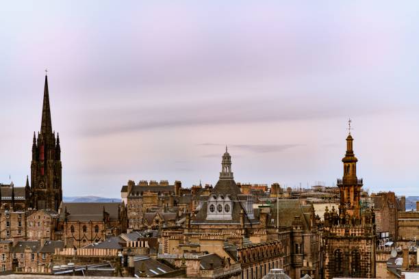 istock View of Edinburgh's historic skyline featuring iconic spires and architecture under a pastel sky. 2200164888