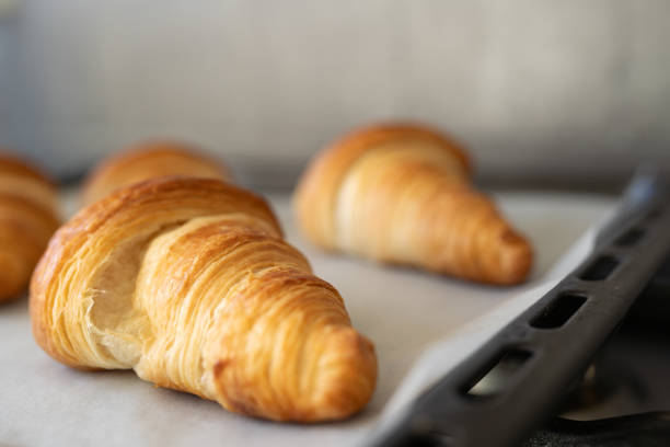 istock Homemade croissants cool on baking paper. 2200165670