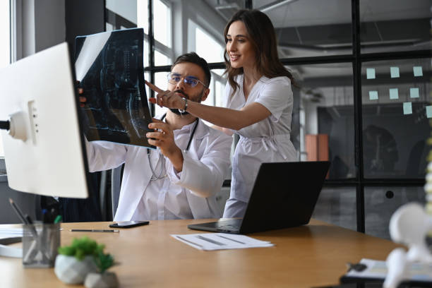 istock Diagnosis, looking at x-ray. Two doctors are in the office 2200167310