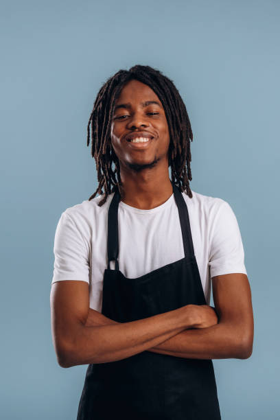 istock Standing, barista is in apron. Black man is in the studio against soft background 2200170067