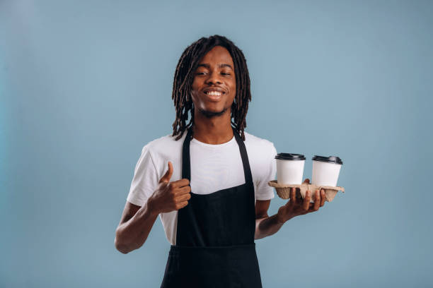 istock Barista is with coffee. Black man is in the studio against soft background 2200170075