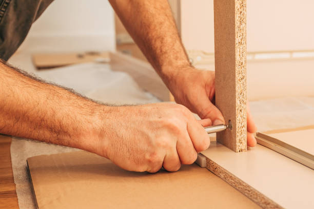 istock Man assembling furniture at home for a DIY project 2200170243