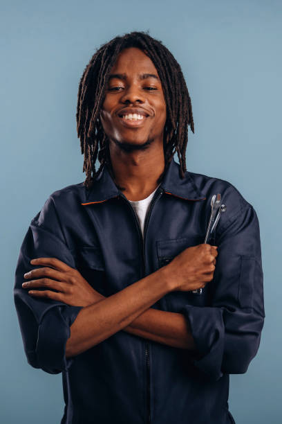 istock Plumber with tools, wrench. Black man is in the studio against soft background 2200170394