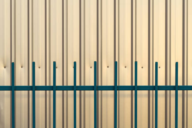 Industrial warehouse corrugated metallic wall and fence as abstract background and copy space