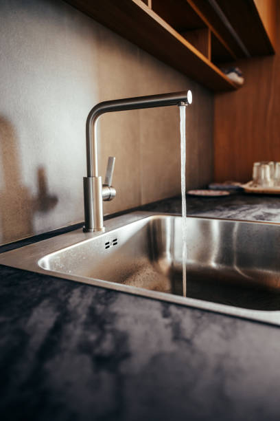 istock Water faucet and metallic sink in modern sleek kitchen 2200170467