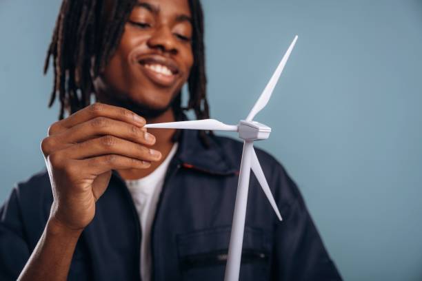 istock Green energy, wind turbine. Black man is in the studio against soft background 2200170498
