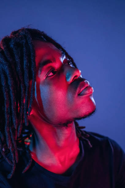 istock African American guy is studio with neon lighting 2200172075