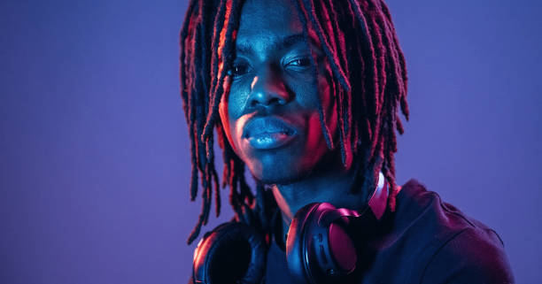 istock Dreadlocks hairstyle, portrait. African American guy is studio with neon lighting 2200172715