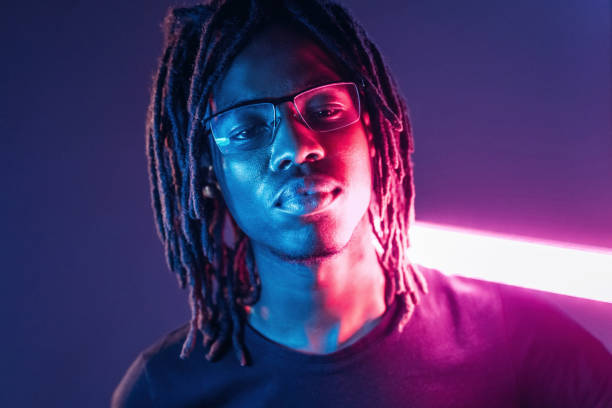 istock Neon lighting equipment. African American guy is studio 2200172877