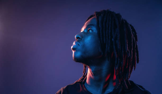 istock Focused close up view. African American guy is studio with neon lighting 2200173033