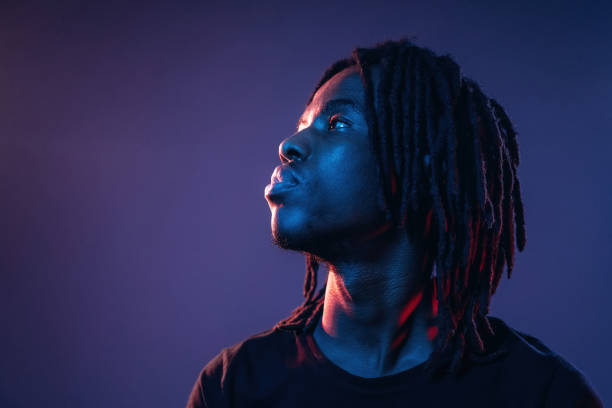 istock Focused close up view. African American guy is studio with neon lighting 2200173041