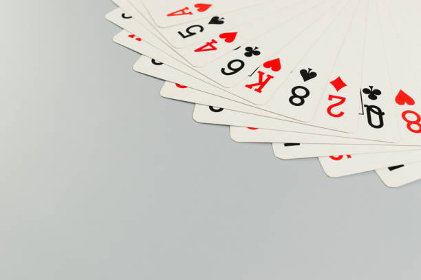 Top view of playing cards on grey background. Board game, poker. Copy space, flat lay.