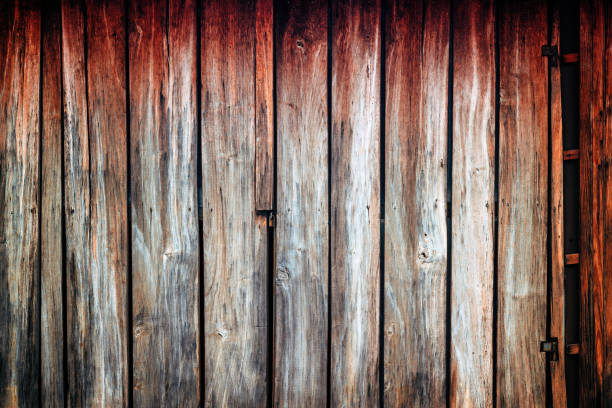 Old worn rustic wooden gate of a shed as background