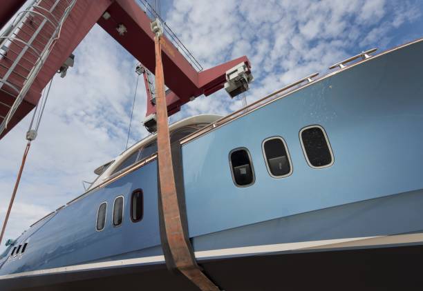 istock At the shipyard. Blue Luxurious yacht ready for launch. Ship building industry. 2200176007