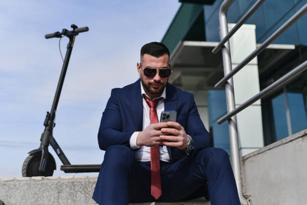 istock Male Supervisor Checking Mails on Smart Phone Looking Focused and Concentrated 2200177534