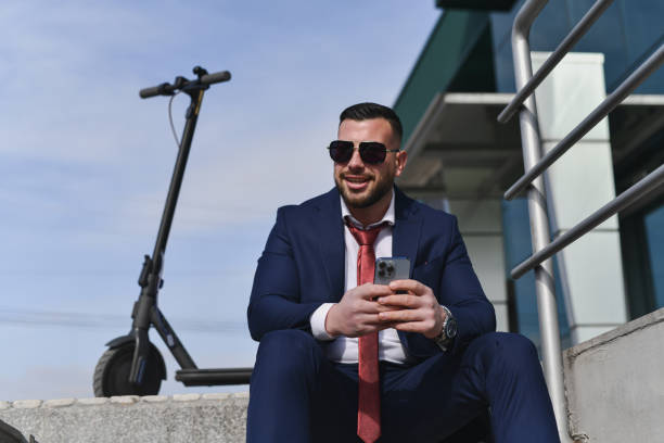 istock Fashionable Male Supervisor Enjoying Work Break Outdoors Checking Social Media 2200177808