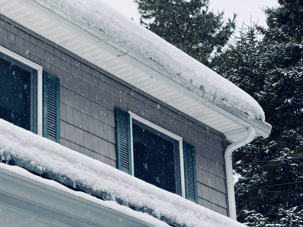 istock Wooden house with rain gutter in winter 2200178184