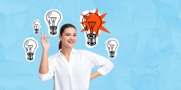 istock Woman smiling with lightbulb illustrations on crumpled blue back 2200179748