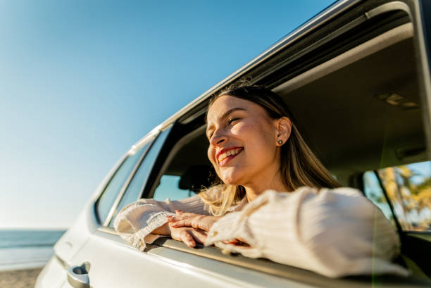 istock Young woman contemplating inside car 2200179962