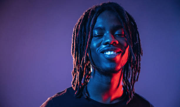 istock Smiling, positive facial expression. African American guy is studio with neon lighting 2200180010