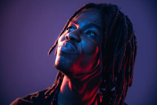 istock Close up portrait. African American guy is studio with neon lighting 2200180056